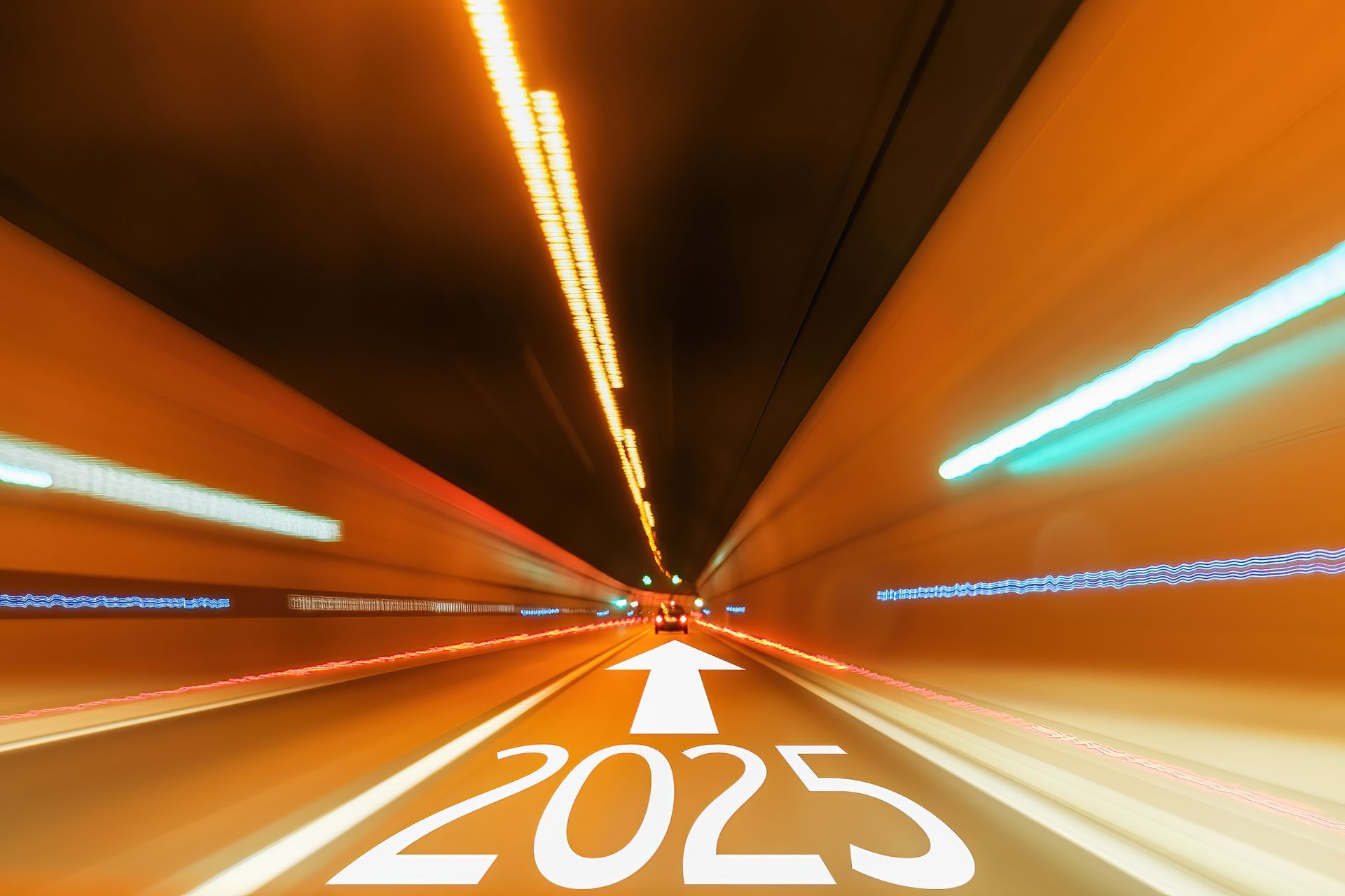 A blurred image of a tunnel with the year 2025 written on the road